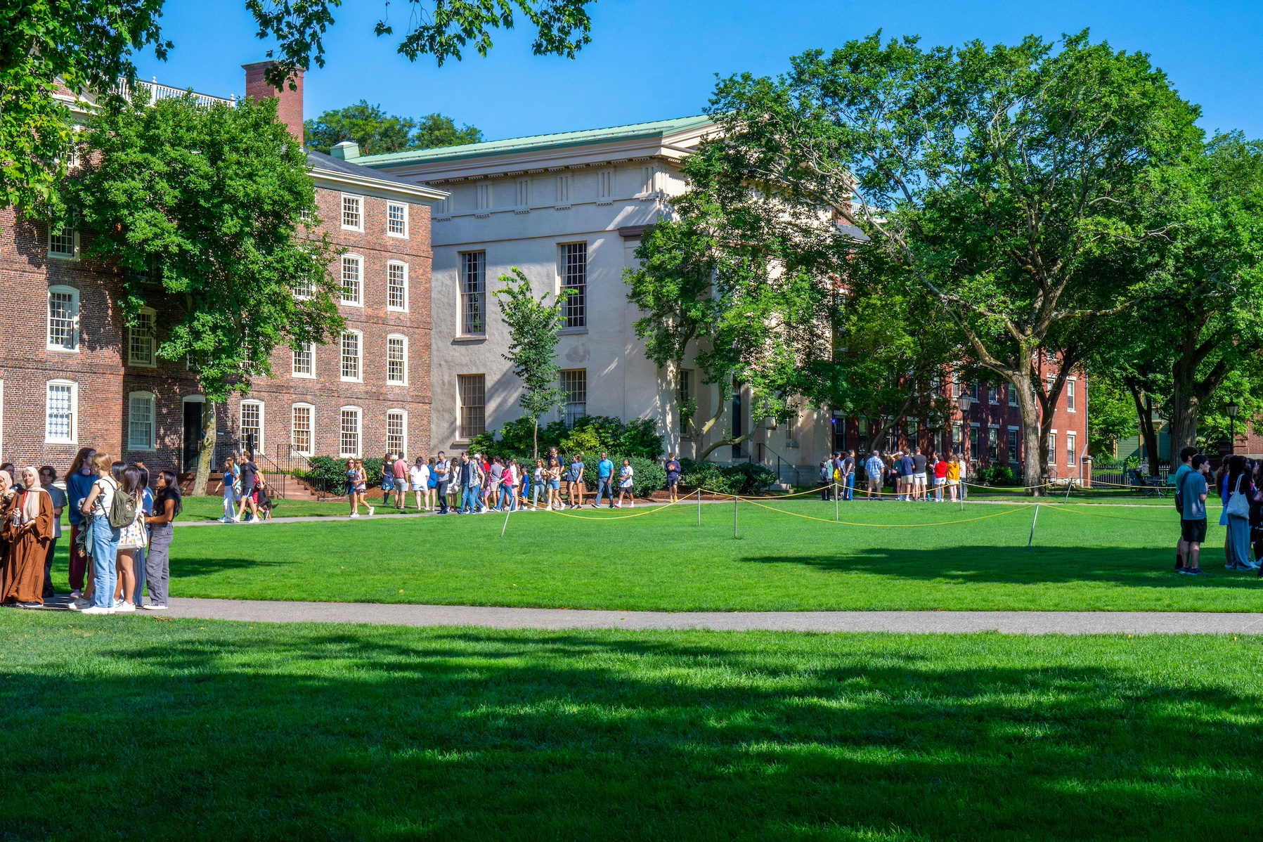 Students touring college campus as they discuss college admissions
